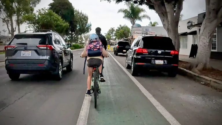 A child rides her bike ona Class II bike lane in Leucadia, Encinitas, California