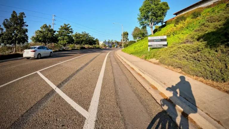 Cyclist POV of riding a bike on a buffered Class II bike lane on Encinitas Boulevard near Quail Gardens Dr. in Encinitas, California