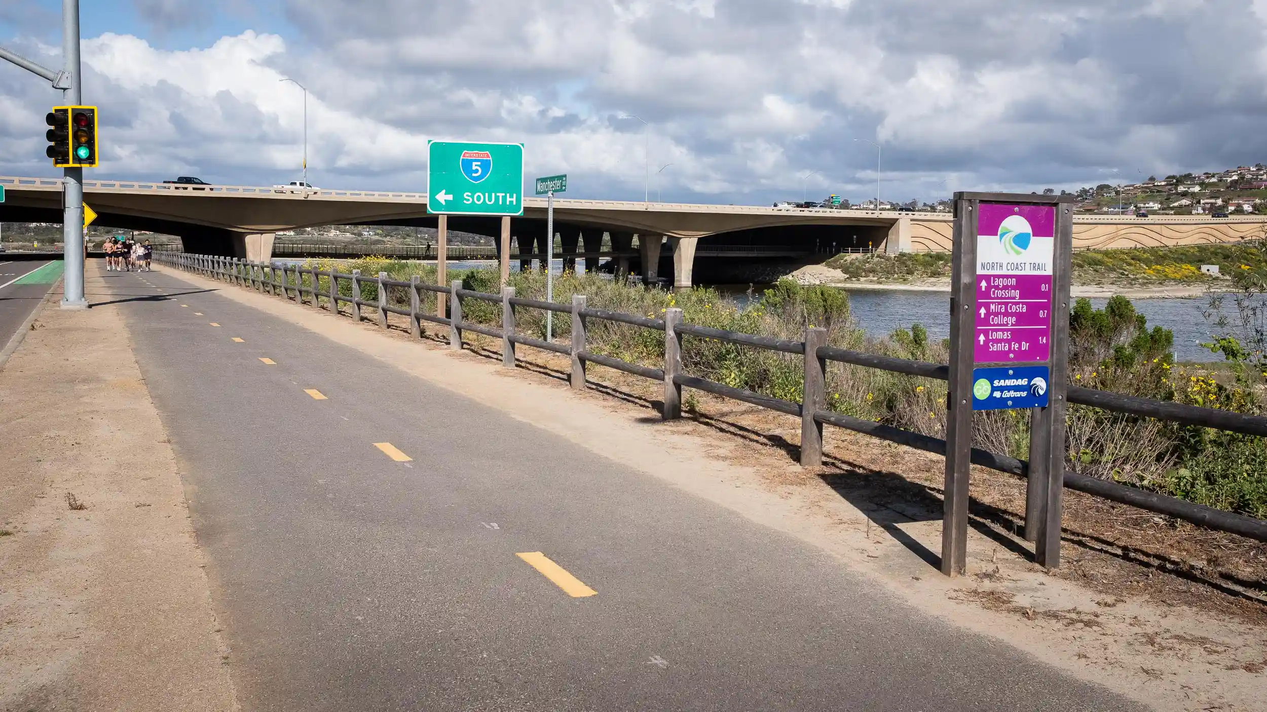 The SANDAG North Coast Trail shared pathway or cycle track alongside Manchester Ave, the San Elijo Lagoon and the Interstate 5 freeway in Encinitas, California.