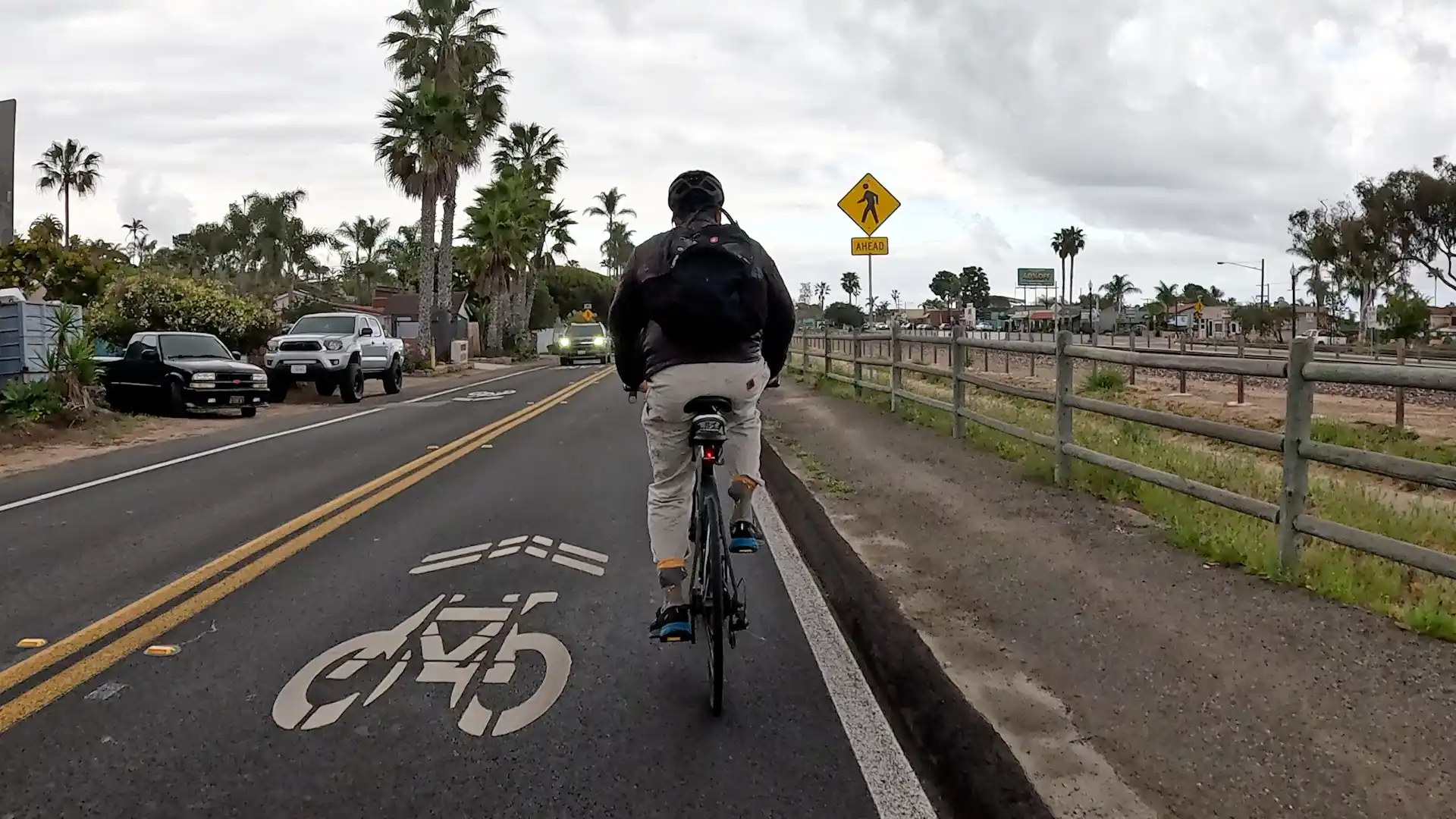Acyclist rides on Vulcan Ave, a Class III Bike Route in Leucadia, Encinitas, California